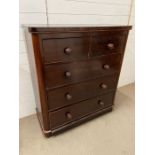 A mahogany chest of drawers, two over three with turned handles (H115cm W103cm D46cm)