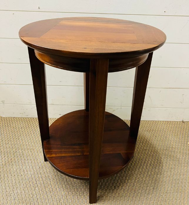 A circular side table with four supporting legs and shelf under (H60cm Dia45cm)