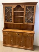 A pine Welsh dresser with glazed doors and base unit with drawers and cupboards (H206cm W150cm
