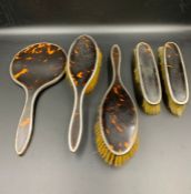 A Five piece silver and tortoiseshell dressing table set