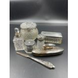 A selection of silver topped vanity items to include five jars, a nail buffer etc