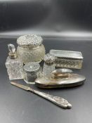 A selection of silver topped vanity items to include five jars, a nail buffer etc