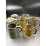 Seven pewter jugs and brass