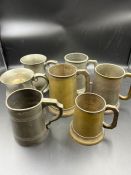 Seven pewter jugs and brass