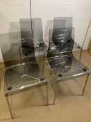 A set of four transparent dining chairs made in Italy