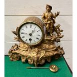 A French mantle clock in gilt with a young man stood on the right AF