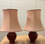A pair of red table lamps