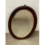 An oval mahogany mirror