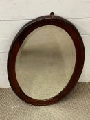 An oval mahogany mirror