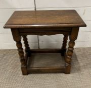 An oak stool on turned legs