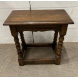 An oak stool on turned legs