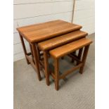 A nest of three teak tables