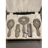 A silver backed dressing table set comprising brushes, comb and mirror in original box by W I
