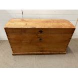 An antique pine trunk with iron metal work handles (H57cm W94cm D52cm)