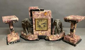 An Art Deco elephant themed pink marble clock and garniture (Pendulum is missing)