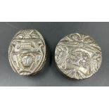 A pair of silver pill boxes