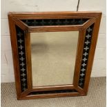 A wooden and metal framed mirror