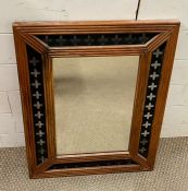 A wooden and metal framed mirror