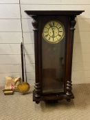 A mahogany wall clock with turn pillar supports to sides, key and weights