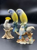 A selection of porcelain parrots and birds