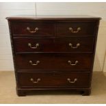 A mahogany two over three chest of drawers with brass drop handles on bracket feet (H105cm W106cm