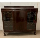 A side cabinet with bow front and glazed doors to side (H127cm W139cm D38cm)