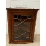 A mahogany wall hanging corner cupboard, glazed front