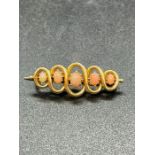 A 15ct gold brooch with five stones. (Total weight 3.7g)
