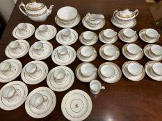 A white and gilt tea service, twelve tea cups, twelve coffee cans, twelve saucers, twelve side