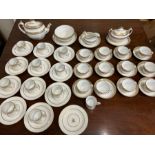 A white and gilt tea service, twelve tea cups, twelve coffee cans, twelve saucers, twelve side