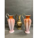 A pair of bohemian peach glass ewers, along with one other