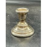 A single silver squat candlestick, hallmarked for Birmingham 1924