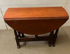 A drop leaf gate leg table with drawer to one end