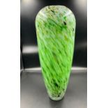 A tall green barrell style vase