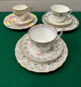 A selection of trio of cups and saucers, various markers