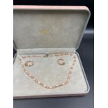 A coral and pearl necklace and earring set