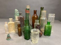 A selection of collectable antique bottles in various conditions and styles.