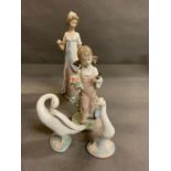 Four Lladro figurines, two swans, a lady in a gown and a little girl gardening