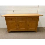 An oak sideboard by Marks and Spencer's, three drawers with three cupboards below