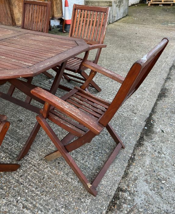 A six seater wooden garden table with folding chairs (H74cm W150cm D87cm) - Image 4 of 7