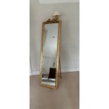 A gilt frame long floor standing mirror