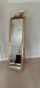 A gilt frame long floor standing mirror