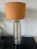 A contemporary glass waved table lamp with chrome details