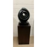 A circular abstract sculpture on plinth (Base H70cm Sq39cm)