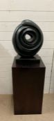 A circular abstract sculpture on plinth (Base H70cm Sq39cm)