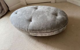 An oval ottoman (120cm x 64cm)