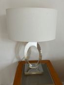 A perplex sculptural lamp with white shade