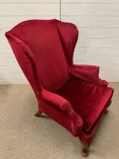 A velvet wing back chair