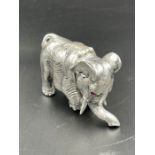 An 84 mark Russian silver model of an elephant with gem set eyes