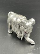 An 84 mark Russian silver model of an elephant with gem set eyes